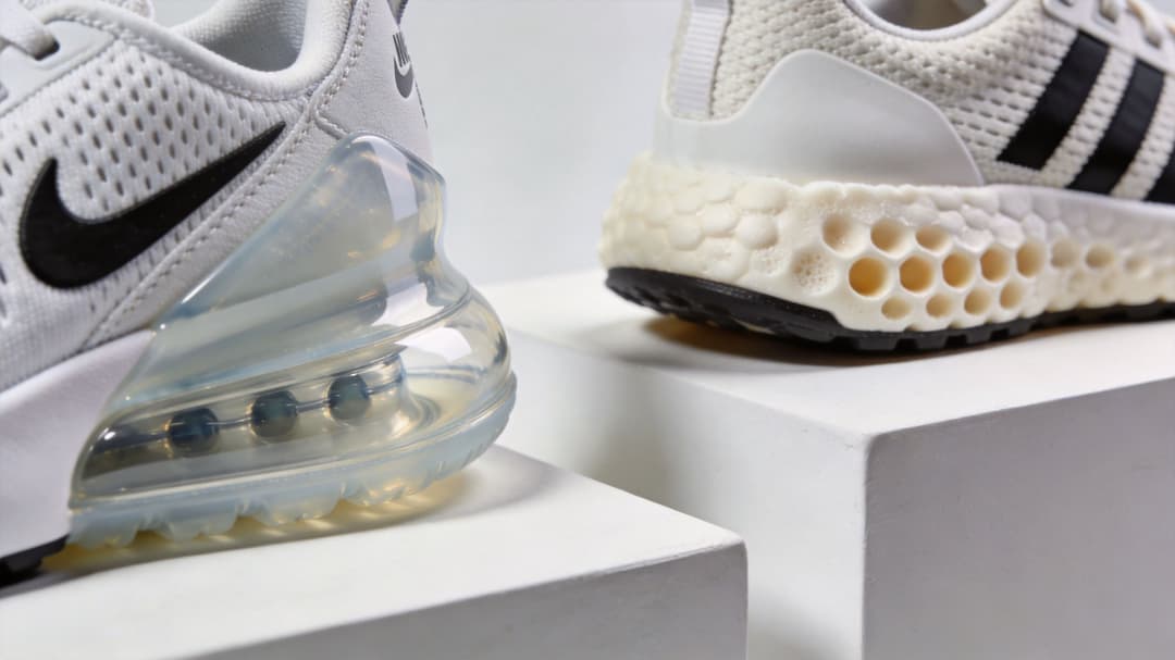 A side-by-side comparison of Nike Air Max and Adidas 4D sneakers on white display platforms.